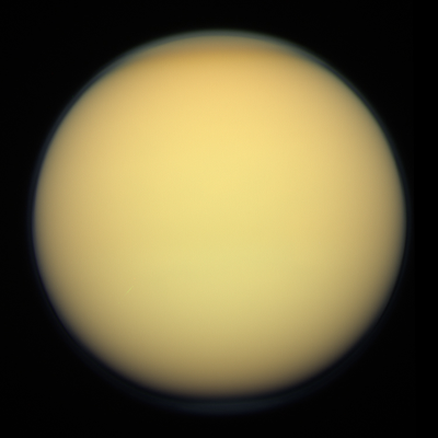 Titan, a moon with a thick, yellow-orange atmosphere that obscures its surface.